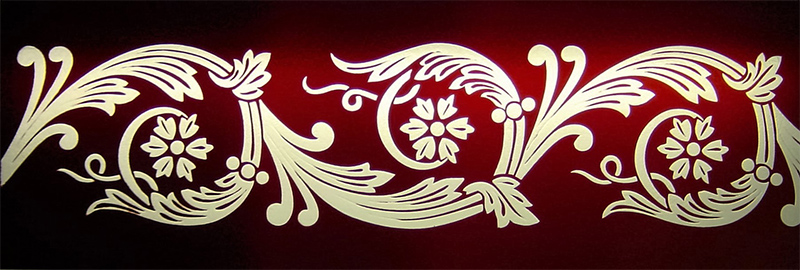 Detailed glass embossing in coloured glass.